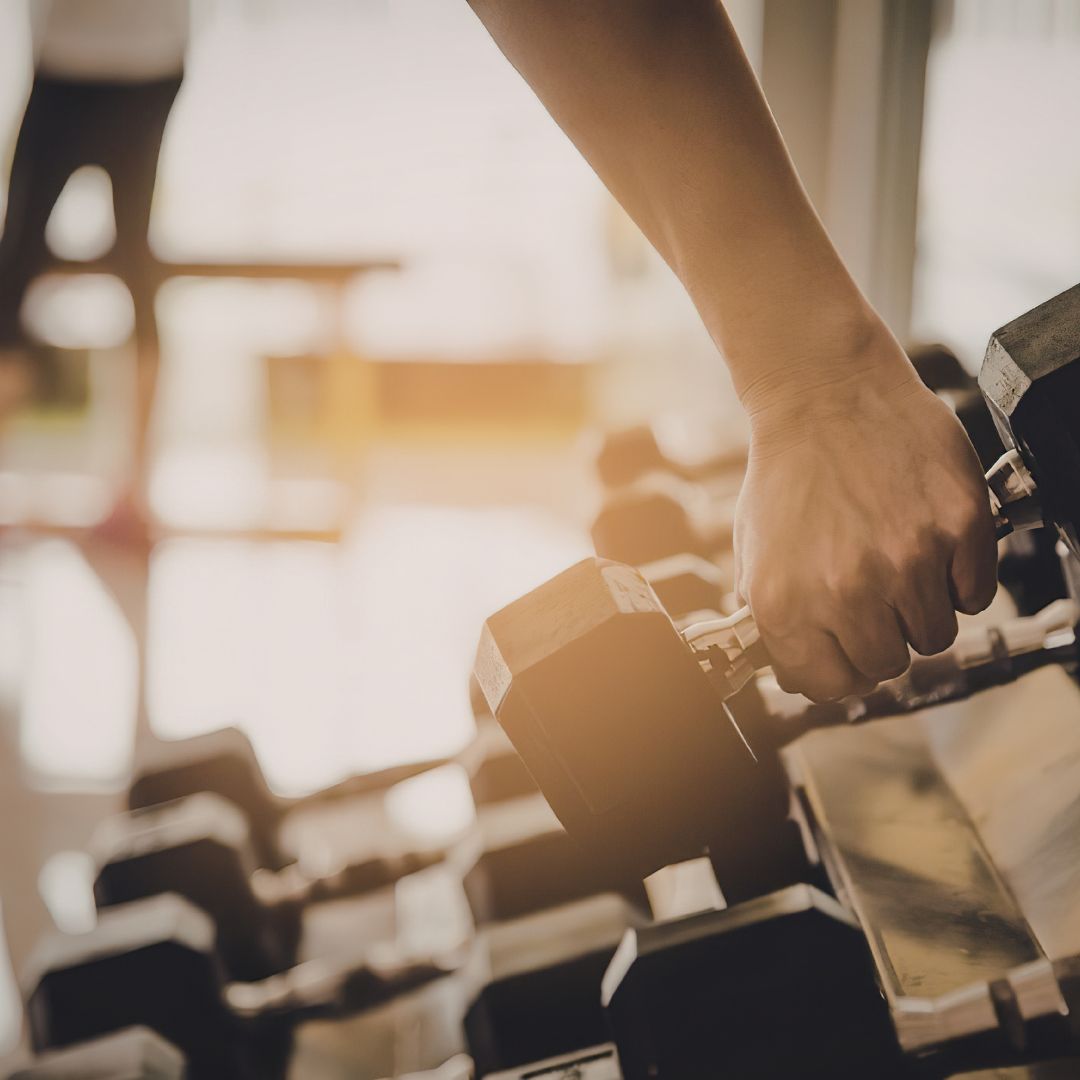 Woman performing strength training exercises to support muscle and metabolic health in PCOS.
